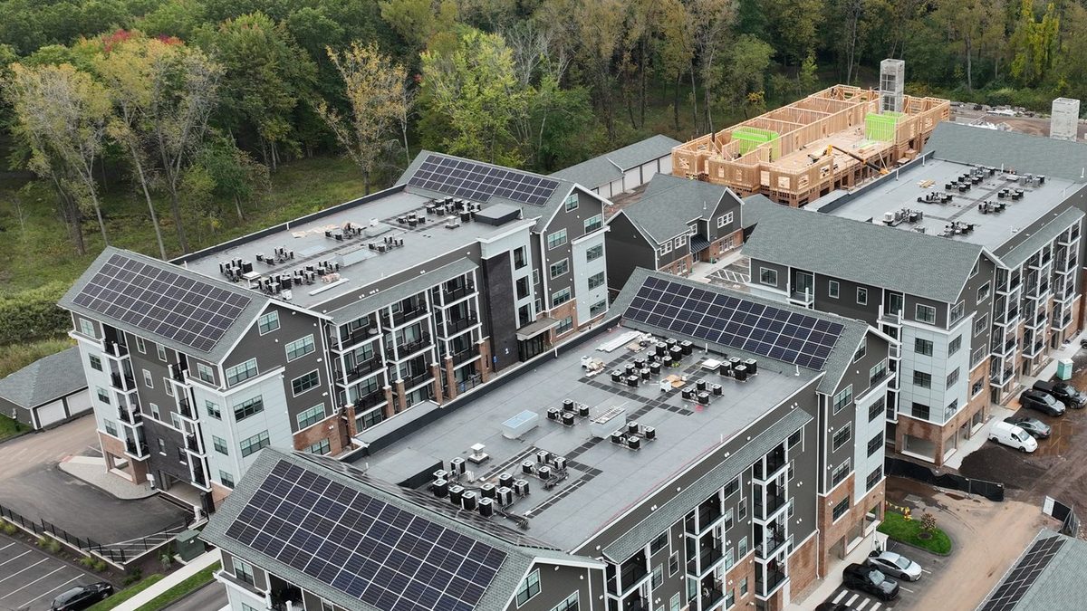 Close aerial of completed building elevations and roof planes