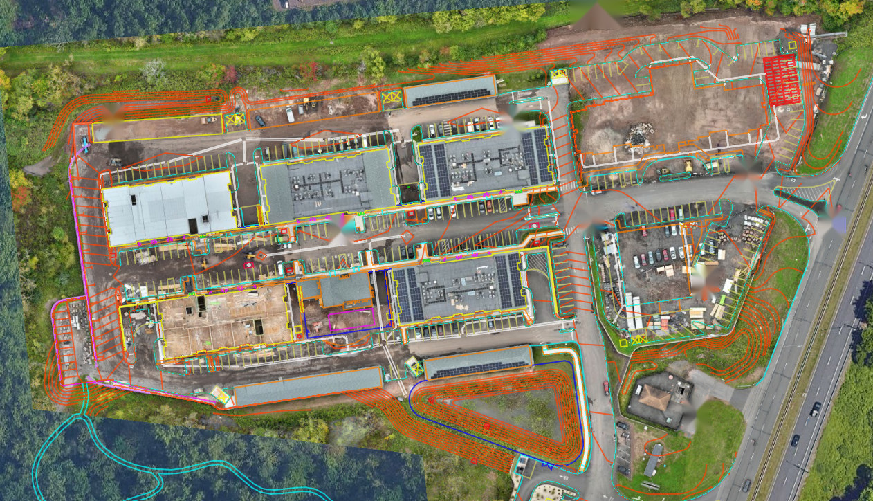 Orthomosaic of a full construction site with the civil design registered on top of it: utilities, contours, erosion control, limits of disturbance, and parking layout