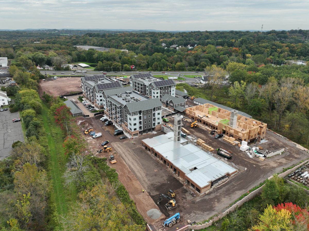 The same aerial view three weeks later, crane removed and the structure framed and roofed